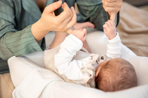 mother plays with newborn baby newborn baby